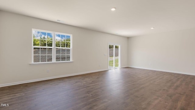 unfurnished room featuring dark wood-style floors, visible vents, recessed lighting, and baseboards