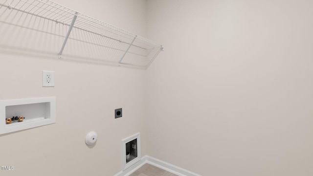 clothes washing area with baseboards, gas dryer hookup, laundry area, electric dryer hookup, and washer hookup