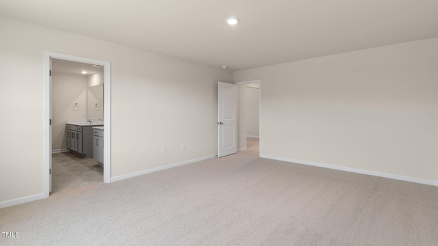 unfurnished bedroom featuring recessed lighting, baseboards, and light carpet