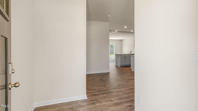 corridor featuring visible vents, recessed lighting, wood finished floors, and baseboards