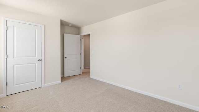 unfurnished bedroom with carpet and baseboards