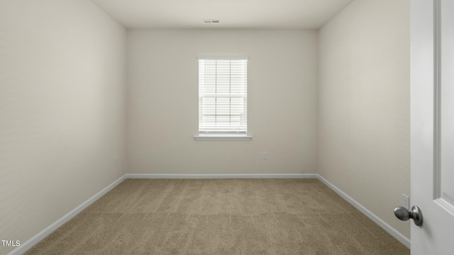 unfurnished room with light colored carpet