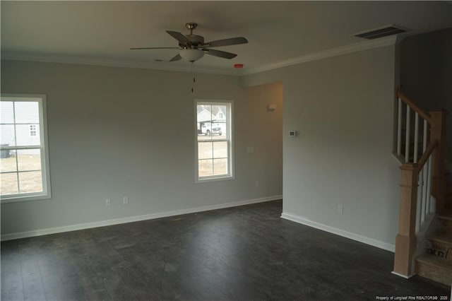 spare room featuring stairs, dark wood-style floors, and crown molding