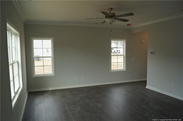 empty room featuring ornamental molding, a wealth of natural light, and dark wood finished floors