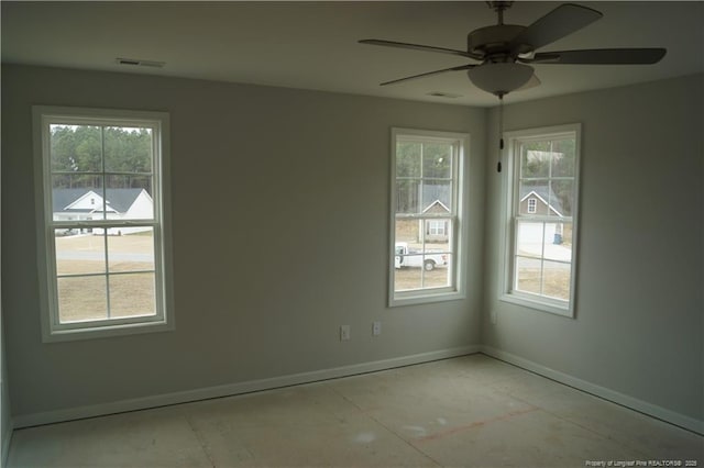 unfurnished room featuring visible vents, ceiling fan, and baseboards