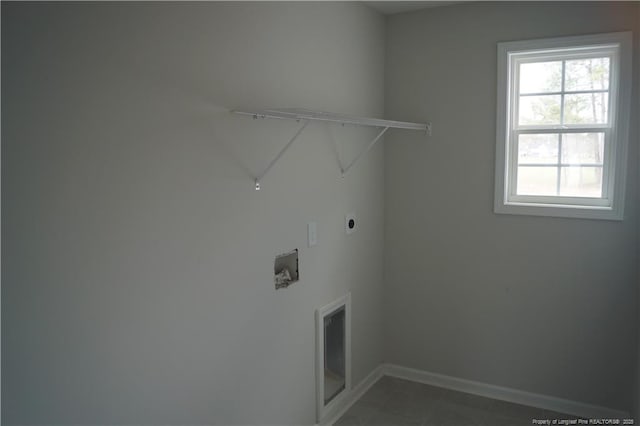 laundry area featuring laundry area, electric dryer hookup, and baseboards