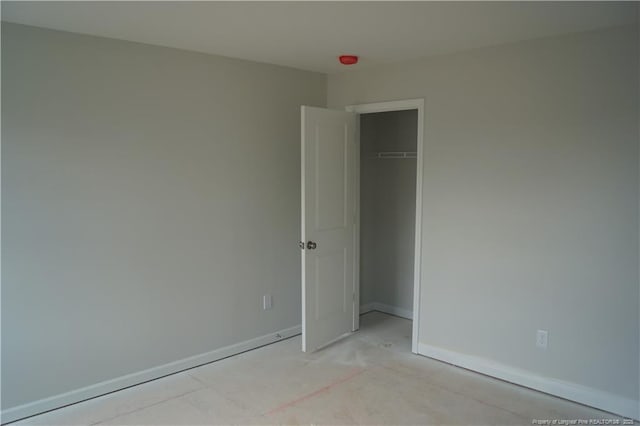 unfurnished bedroom featuring baseboards and a closet