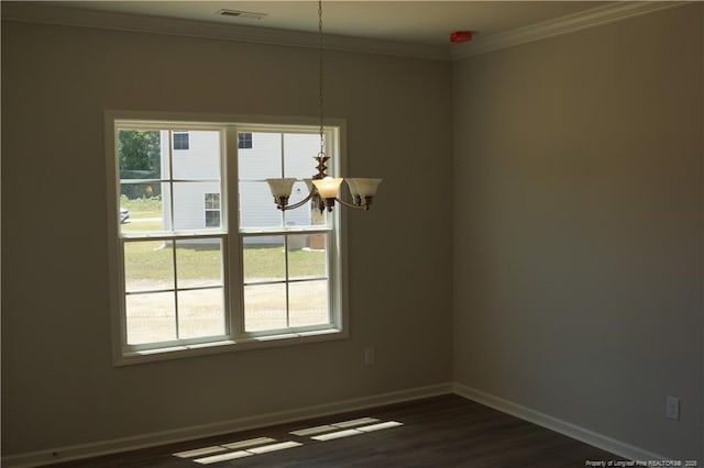 spare room with visible vents, baseboards, a notable chandelier, ornamental molding, and dark wood-type flooring