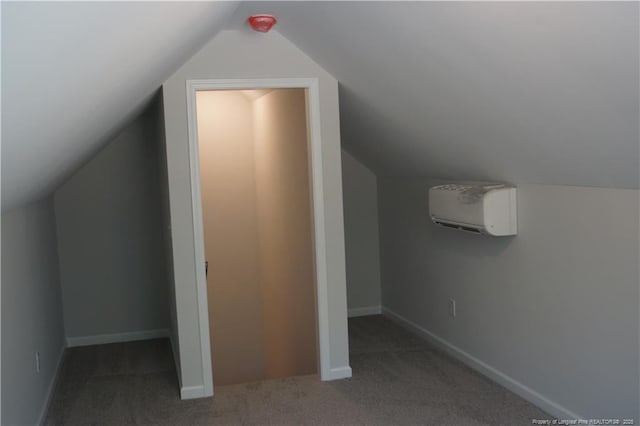 bonus room featuring carpet floors, an AC wall unit, baseboards, and lofted ceiling
