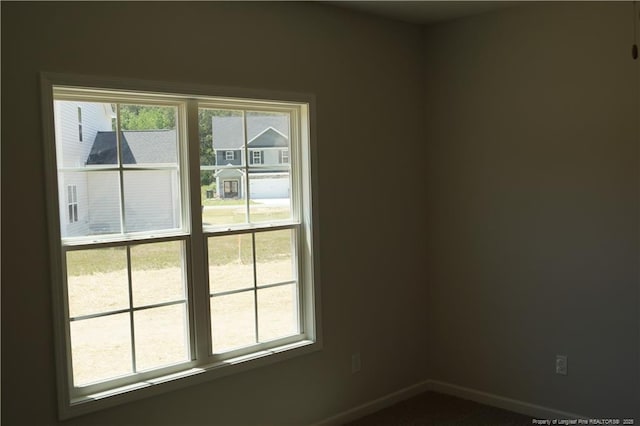 spare room featuring baseboards