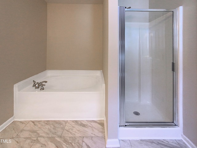 bathroom featuring shower with separate bathtub