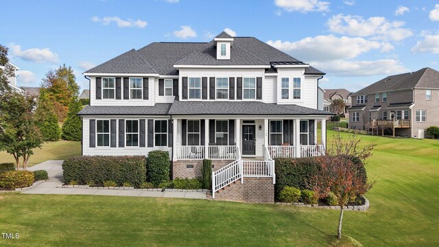 view of property featuring a front yard and a sunroom