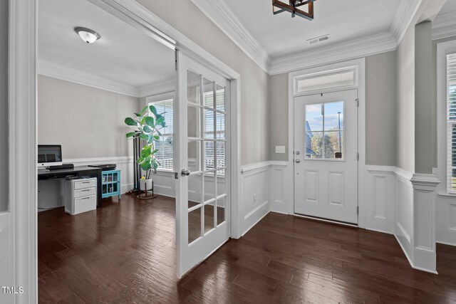 foyer entrance with ornamental molding, french doors, and dark hardwood / wood-style flooring