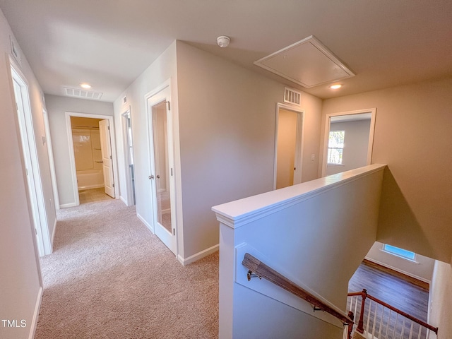 corridor featuring light carpet