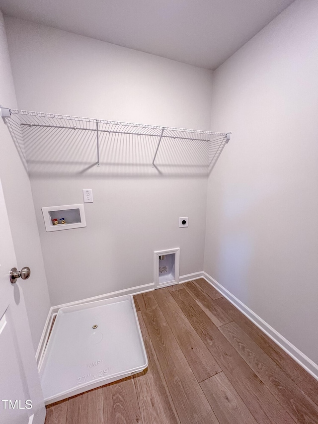 clothes washing area with electric dryer hookup, hookup for a washing machine, and hardwood / wood-style flooring