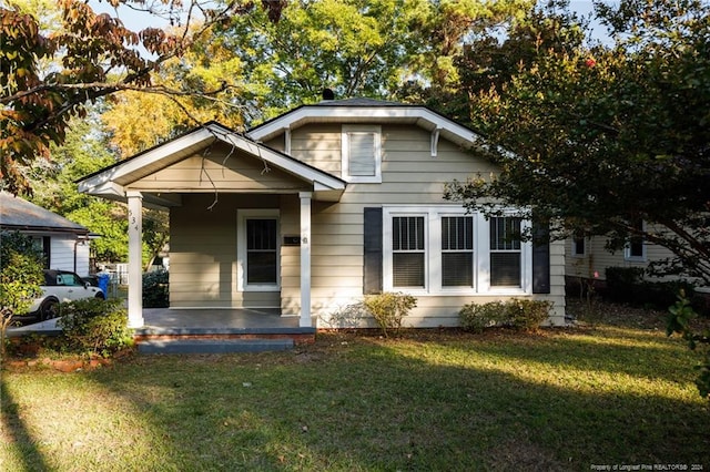 bungalow-style house with a front lawn and a porch