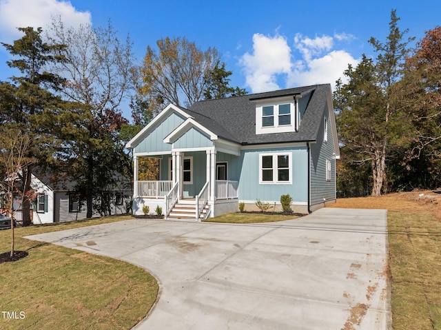 view of front of home featuring covered porch and a front lawn