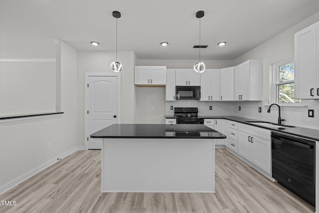 kitchen featuring black appliances, sink, a kitchen island, and white cabinets