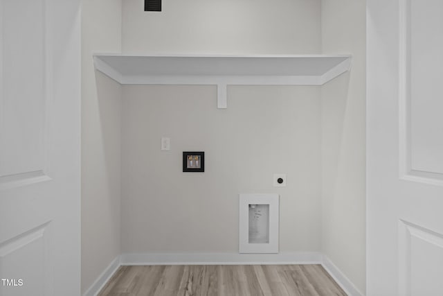 washroom featuring hookup for an electric dryer and light hardwood / wood-style floors