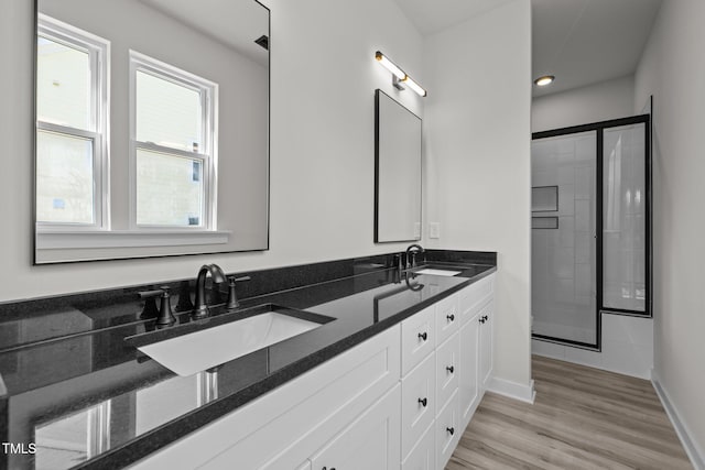 bathroom featuring vanity, walk in shower, and hardwood / wood-style floors