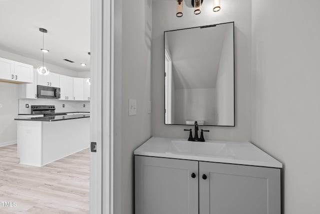 bathroom featuring sink, wood-type flooring, and backsplash