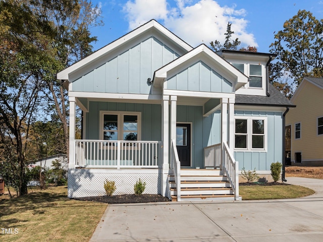 view of front of home with covered porch and a front yard