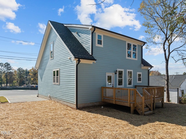 rear view of house with a wooden deck