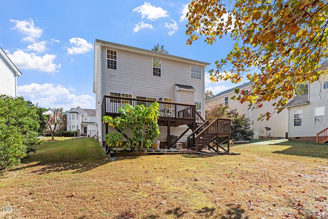 rear view of property featuring a deck and a yard