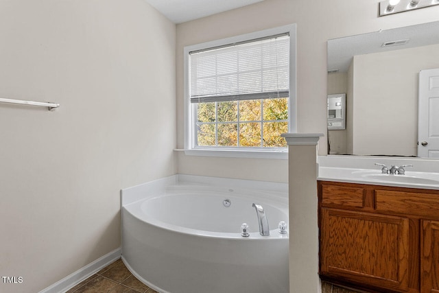 bathroom with vanity, a tub, and tile patterned floors