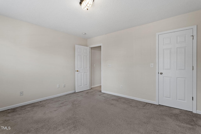 unfurnished room with light carpet and a textured ceiling