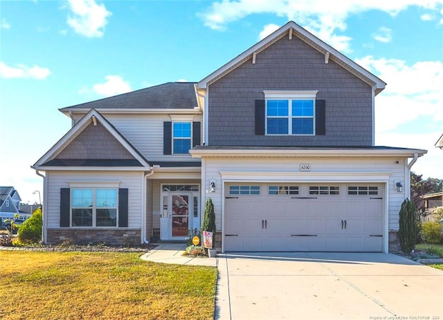 craftsman-style home with a garage and a front lawn