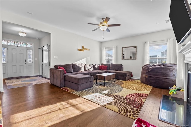 living room featuring ceiling fan and hardwood / wood-style floors