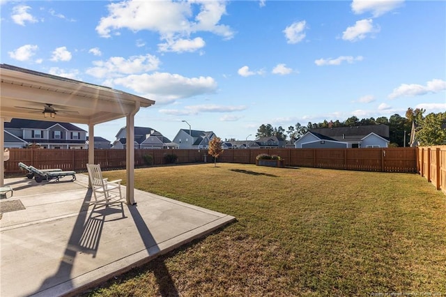 view of yard with a patio area and ceiling fan