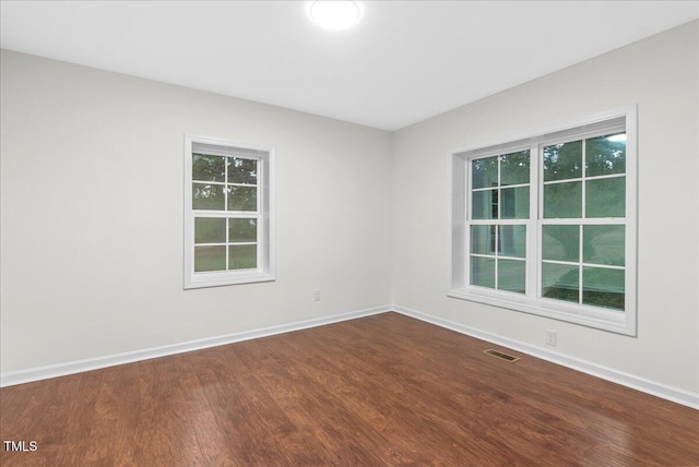 spare room with hardwood / wood-style floors