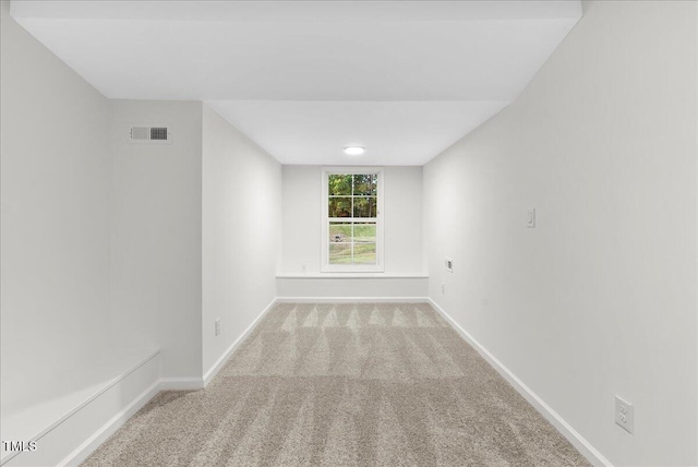 unfurnished room with light colored carpet