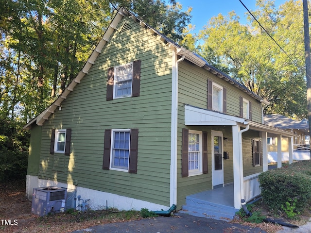 view of home's exterior with central AC unit and a porch