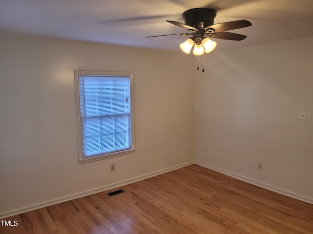 empty room featuring ceiling fan and hardwood / wood-style floors