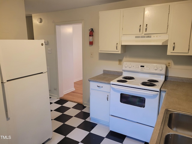 kitchen with white cabinets, exhaust hood, and white appliances