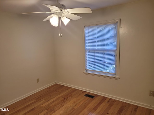 empty room with ceiling fan and hardwood / wood-style floors