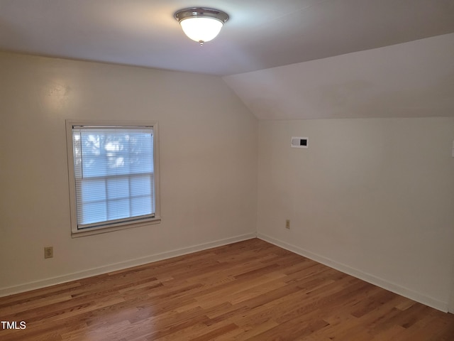 bonus room featuring vaulted ceiling and hardwood / wood-style flooring