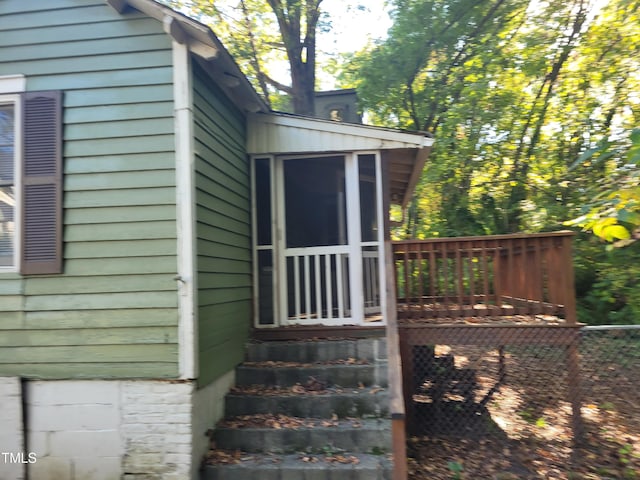 view of exterior entry featuring a deck