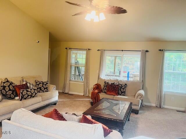 living room featuring lofted ceiling, carpet floors, and ceiling fan