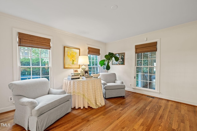 sitting room featuring crown molding and wood-type flooring