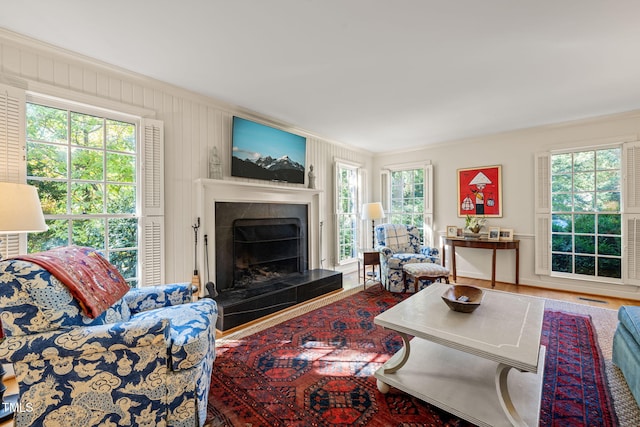 living room with ornamental molding and wood-type flooring