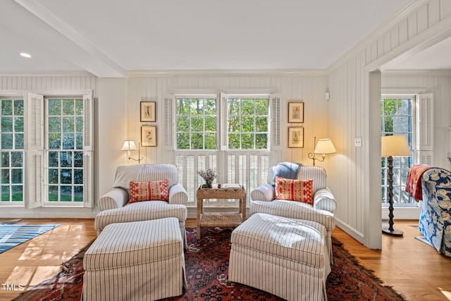 sitting room featuring ornamental molding, a healthy amount of sunlight, and hardwood / wood-style floors