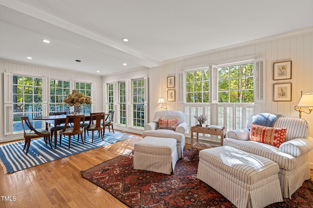 interior space featuring ornamental molding, hardwood / wood-style flooring, and beamed ceiling