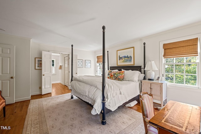 bedroom featuring ornamental molding and wood-type flooring