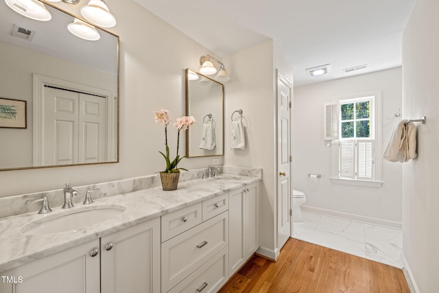 bathroom with vanity, hardwood / wood-style floors, and toilet