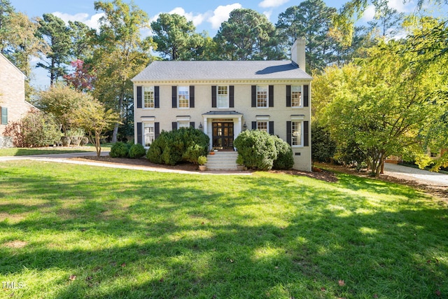 colonial inspired home with a front yard