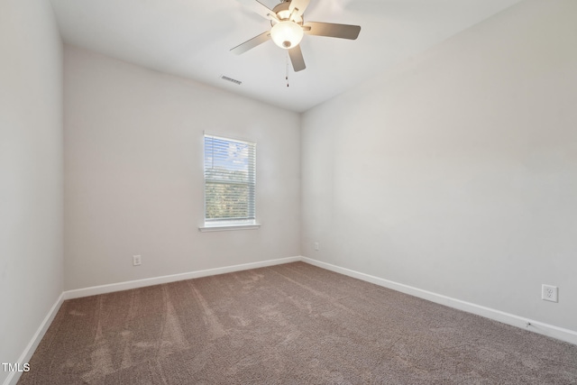 carpeted spare room with ceiling fan